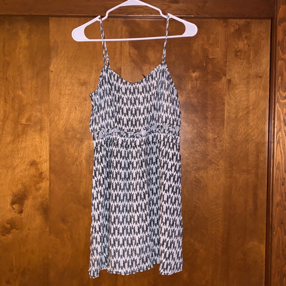 Thin strap dress with open mid-drift.